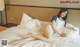 A woman laying on top of a bed in a hotel room.