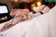 A woman laying on top of a bed with her feet up.